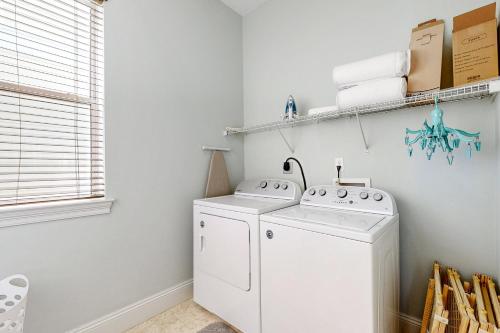 a white laundry room with a washer and dryer at Villages of Crystal Beach Family Tides in Destin