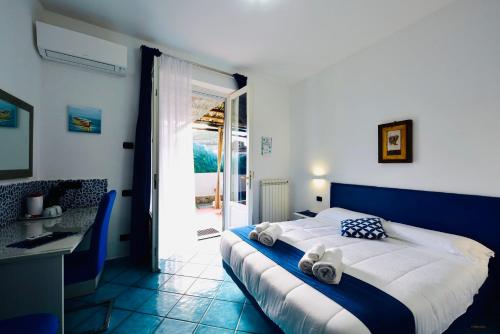a bedroom with a large bed with towels on it at Eden Holiday in Minori