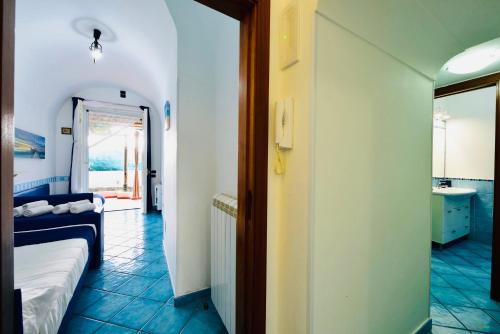 a room with a bed and a bathroom with a mirror at Eden Holiday in Minori