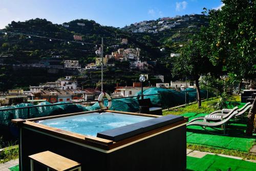 a hot tub with a view of a city at Eden Holiday in Minori