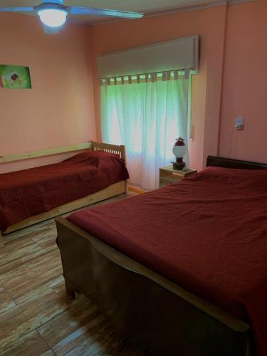a bedroom with two beds and a window at Sanguinetti in Colón