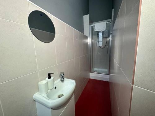 a bathroom with a toilet and a sink and a shower at Modern 3-Bed Haven in West Midlands! in Birmingham