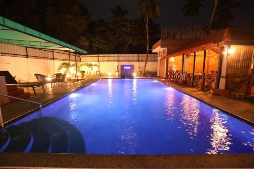 a swimming pool at night with blue illumination at Athulya Resort -Leisure and Luxury cottages from EMBEHolidays in Kottaikadu