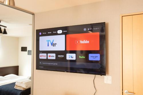a flat screen tv hanging on a wall at Relax Lounge TOKYO in Tokyo