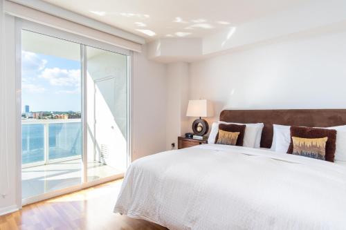 a bedroom with a large bed and a large window at Golden Bay 805 in Miami Beach