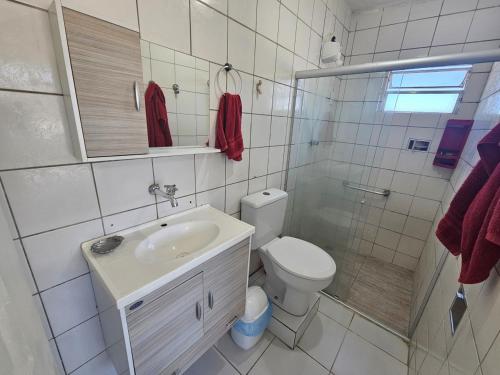 a bathroom with a toilet and a sink and a shower at Cobertura no Pina in Recife