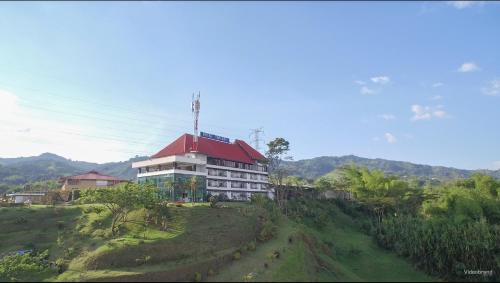 a large building with a red roof on a hill at HOTEl TANGARA in Pereira