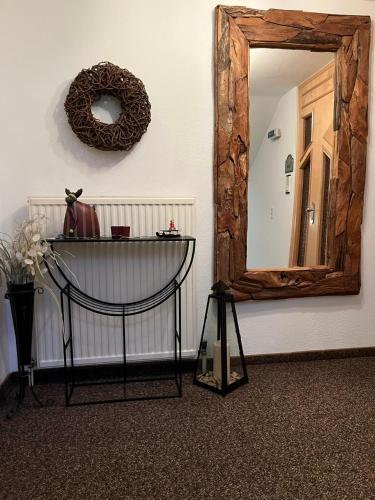 a mirror on a wall with a table in front at Haus Paznaun in Kappl