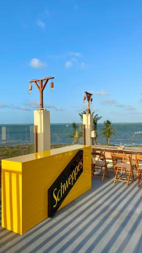 a group of tables and benches on a beach at Pousada Delta Village in Tutóia