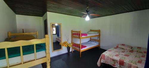 a bedroom with two bunk beds and a bed at Hostel e Pousada Araquari in Paraty