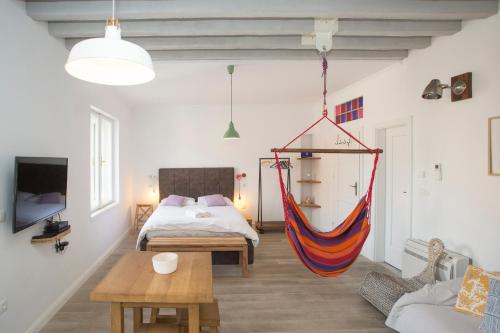 a room with a bed and a hammock in it at Stylish Theatre Apartments in Split