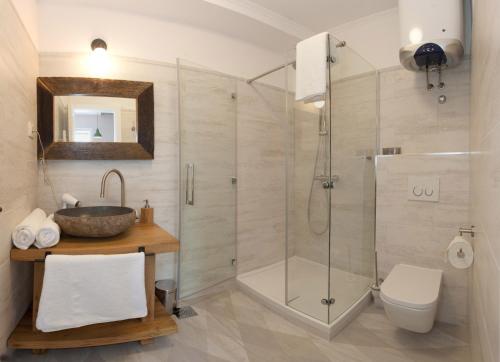 a bathroom with a shower and a toilet and a sink at Stylish Theatre Apartments in Split