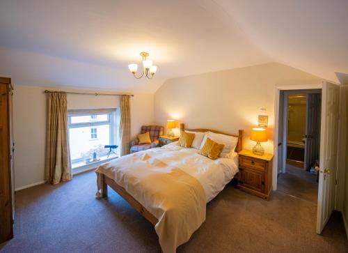 a bedroom with a large bed and a window at Hope Terrace in Matlock