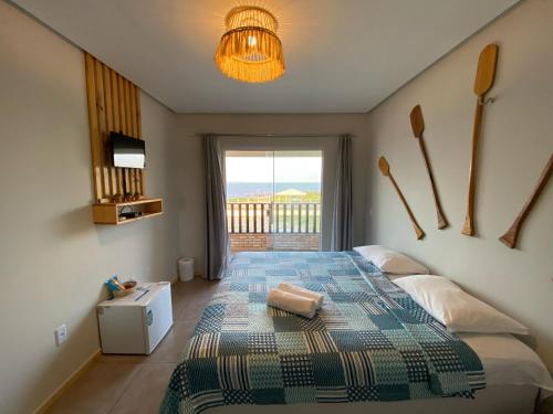 a bedroom with a bed with a view of the ocean at Pousada Delta Village in Tutóia