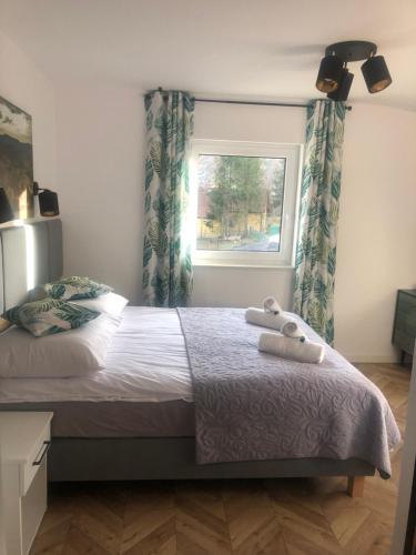 a bedroom with a bed with two towels on it at Wiślańskie Doliny in Wisła