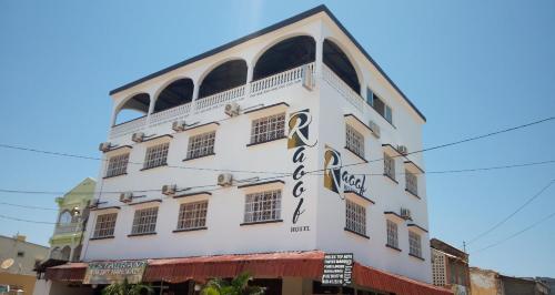 a white building with a sign on it at RAOOF HOTEL in Mahajanga