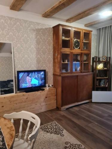 een woonkamer met een televisie en een houten entertainmentcentrum bij Margus rentals in Võru