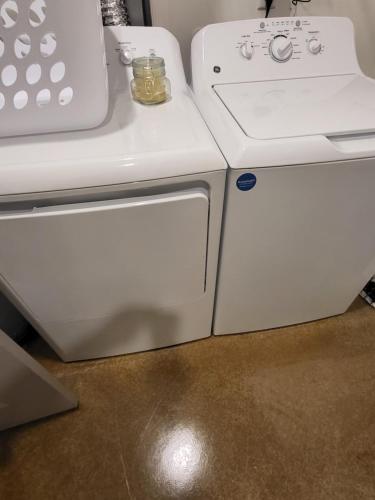 a white washer and dryer next to a stove at Quaint one bedroom apartment in Greensboro