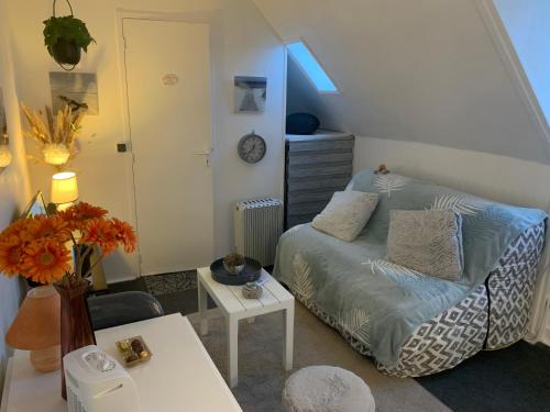 a small room with a bed and a table at 45 Grande Rue bis in Ault
