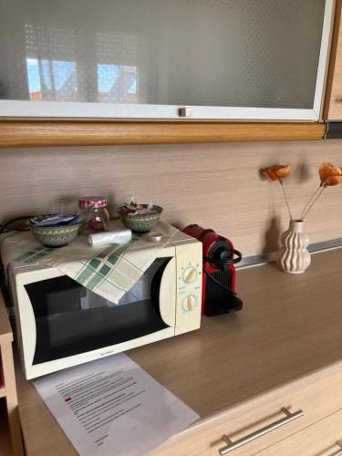 a microwave sitting on top of a counter at Small apartment, great view! in Veria
