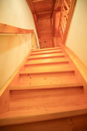 a staircase with wooden steps in a building at Dům na Krásné ve Středohoří in Vlastislav