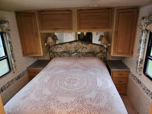 a large bed in the back of an rv at Dark Ridge HideOut in Elk Park