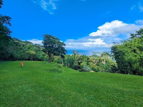 a person standing in a field of green grass at Ponderosa Golf and Resort in Puerto Galera
