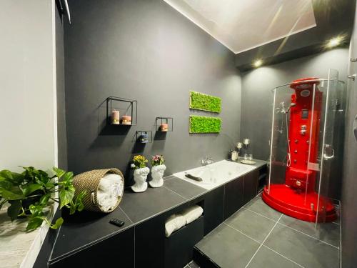 a bathroom with a red shower and a sink at A Casa di Clu - your private SPA in Palermo