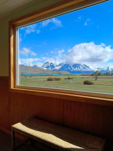 a window with a view of a mountain view at CABAÑA ESTANCIA LAZO in Torres del Paine