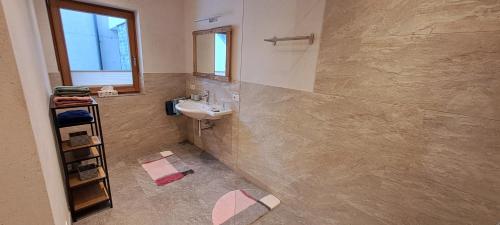 a bathroom with a sink and a mirror at Ferienwohnung Widmann in Jochberg