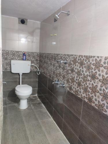 a bathroom with a toilet and a shower at Blue Diamond in Chennai