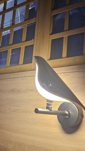 a bird house sitting on the floor in front of a door at Grey Aqua SPA by Secret Apartament in Gdańsk