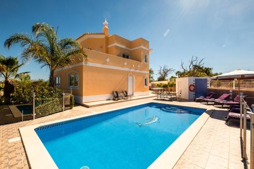 a swimming pool in front of a villa at Villa Culebra by Algarve Vacation in Albufeira