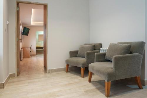 a room with three chairs and a mirror at Cabañas Tierra Mistica in Ushuaia