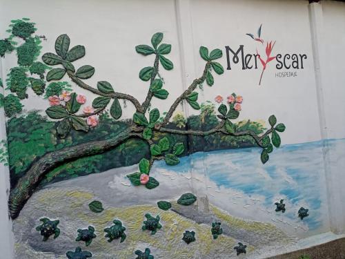 a painting of a tree on a wall at Hospedaje Meryscar in Tortuguero