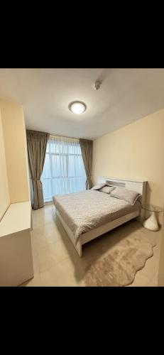 a bedroom with a bed and a large window at Dream Beach View in Ajman 