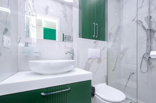 a white bathroom with a sink and a shower at Latorre Hotel in Yerevan