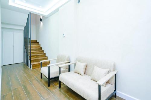 a living room with a couch and a staircase at Latorre Hotel in Yerevan