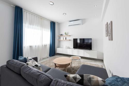 a living room with a couch and a table at Kition City Apartments - Central Location in Larnaca