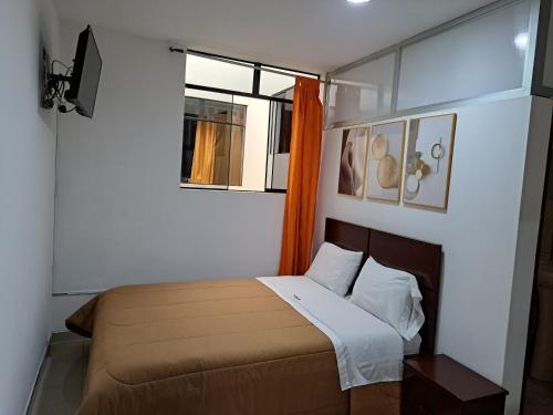 a small bedroom with a bed and a window at TintayaHotel in Chachapoyas