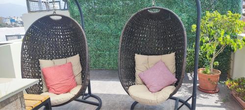 two chairs with pillows sitting on a patio at Hotel Los Tambos Boutique in Arequipa