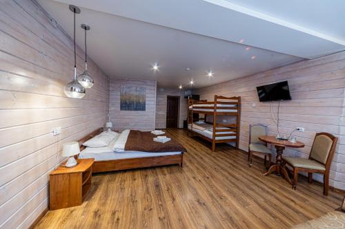 a bedroom with a bed and a bunk bed and a desk at Готель Поляницький in Bukovel