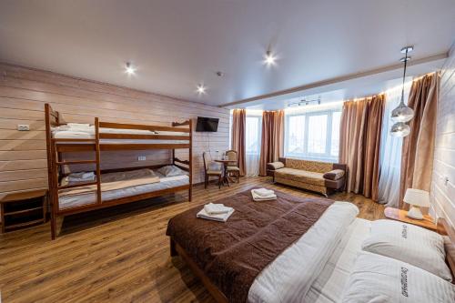 a bedroom with two bunk beds and a couch at Готель Поляницький in Bukovel