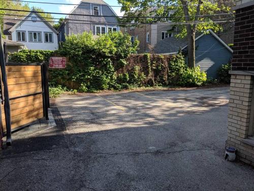 a driveway with a gate in a residential neighborhood at The Bright Retreat in Andersonville in Chicago
