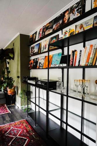 a room with a book shelf filled with books at Country Penthouse in Falun