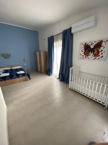 a baby room with a crib and a window at VILLA MANIVA in Ginosa Marina