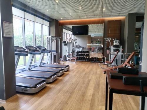 a gym with treadmills and machines in a room at Intimate Studio Apartment - Mirage Residence in Accra