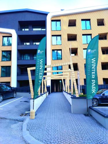 a parking lot with signs in front of a building at WinterHome2 in Bjelašnica