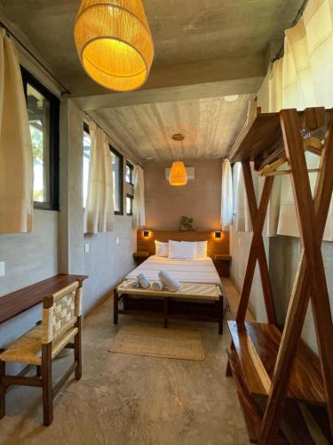 a bedroom with a bunk bed and a ladder at Nectar Hotel, Cafe, Cowork - Adults Only in Puerto Escondido