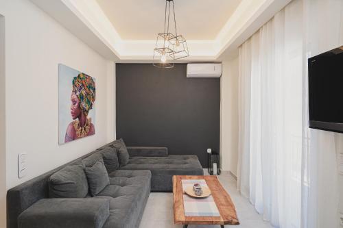 a living room with a couch and a table at Rene Luxury Home in Zakynthos Town